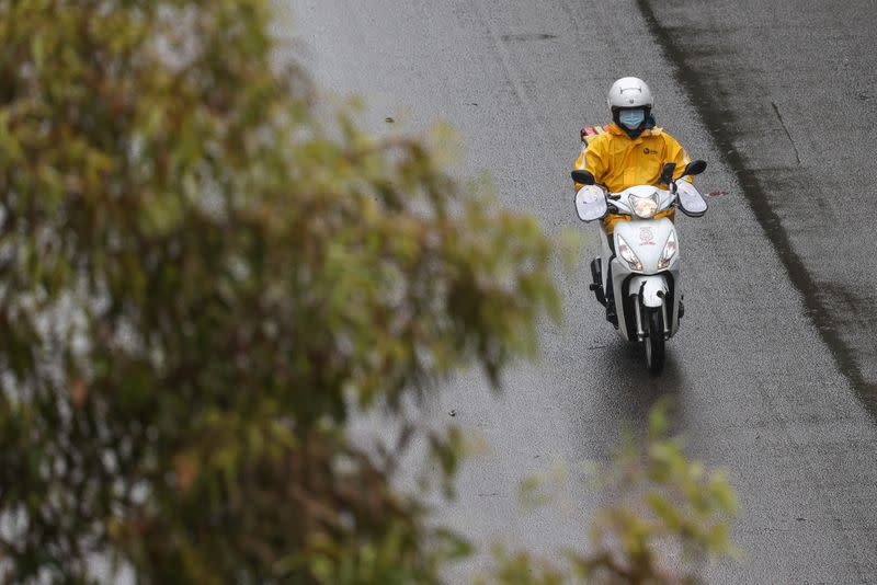 A delivery courier wears a mask in Sydney