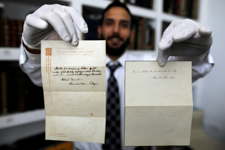 Gal Winner, owner and manager of the Winner's auction house in Jerusalem, on October 19, 2017 displays two notes written by Albert Einstein in 1922 on hotel stationary from the Imperial Hotel in Tokyo, Japan