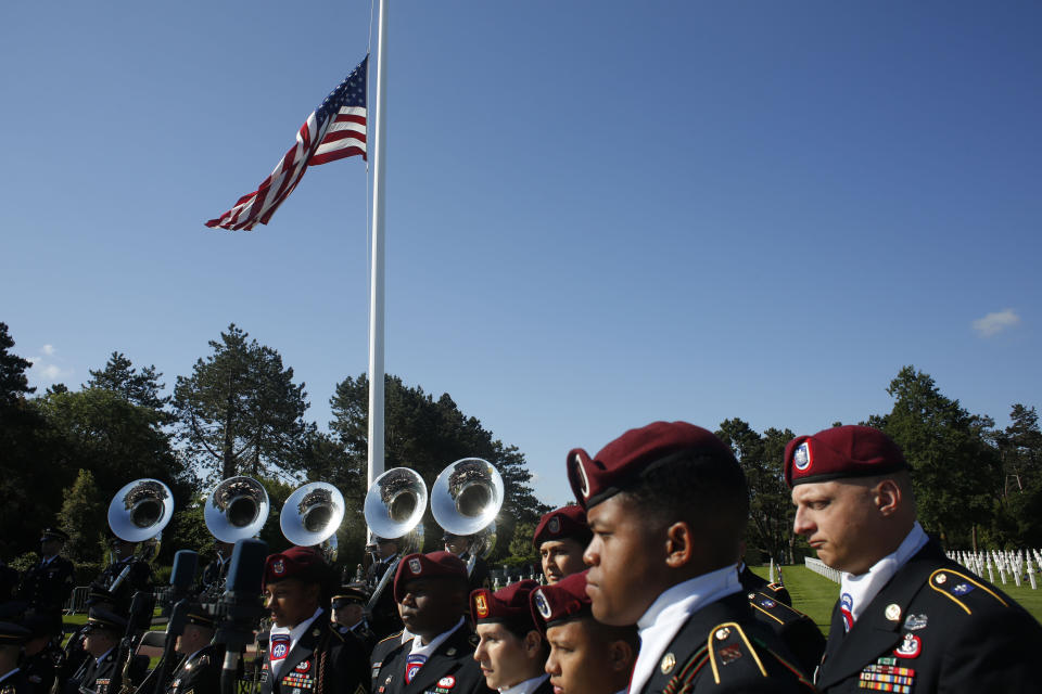 US Army soldiers, based in Germany, stand near the American flag prior to a ceremony to mark the 75th anniversary of D-Day at the Normandy American Cemetery in Colleville-sur-Mer, Normandy, France, Thursday, June 6, 2019. World leaders are gathered Thursday in France to mark the 75th anniversary of the D-Day landings. (AP Photo/Thibault Camus)