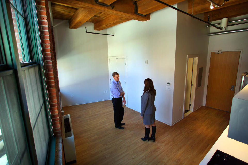 Sam Yarborough and Jessica Ryan, property manager for Greystar, stand in the living room/bedroom area of a 374-square-foot apartment going for $1699 per month .