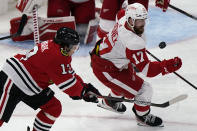 Detroit Red Wings defenseman Filip Hronek, right, controls the puck next to Chicago Blackhawks center Mattias Janmark during the third period of an NHL hockey game in Chicago, Saturday, Feb. 27, 2021. (AP Photo/Nam Y. Huh)