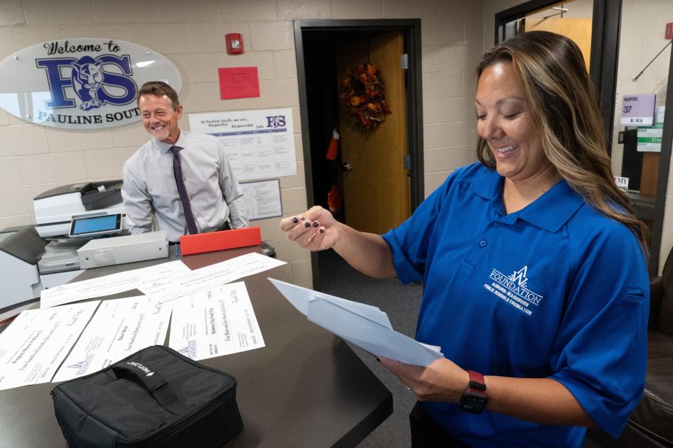 Jill Griego, president of the Auburn-Washburn Public Schools Foundation, works with superintendent Scott McWilliams to organize the grants they handed out Wednesday at Pauline South. For the past 25 years, the foundation has helped teachers by distributing mini cash grants for individual projects like field trips or classroom equipment. This year's grants totaled $64,222.