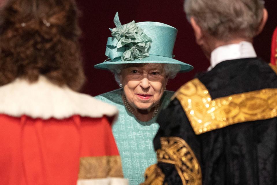 Britain's Queen Elizabeth talks with officials following her speech during at the State Opening of Parliament at the Palace of Westminster in London, Britain December 19, 2019.  Richard Pohle/Pool via REUTERS