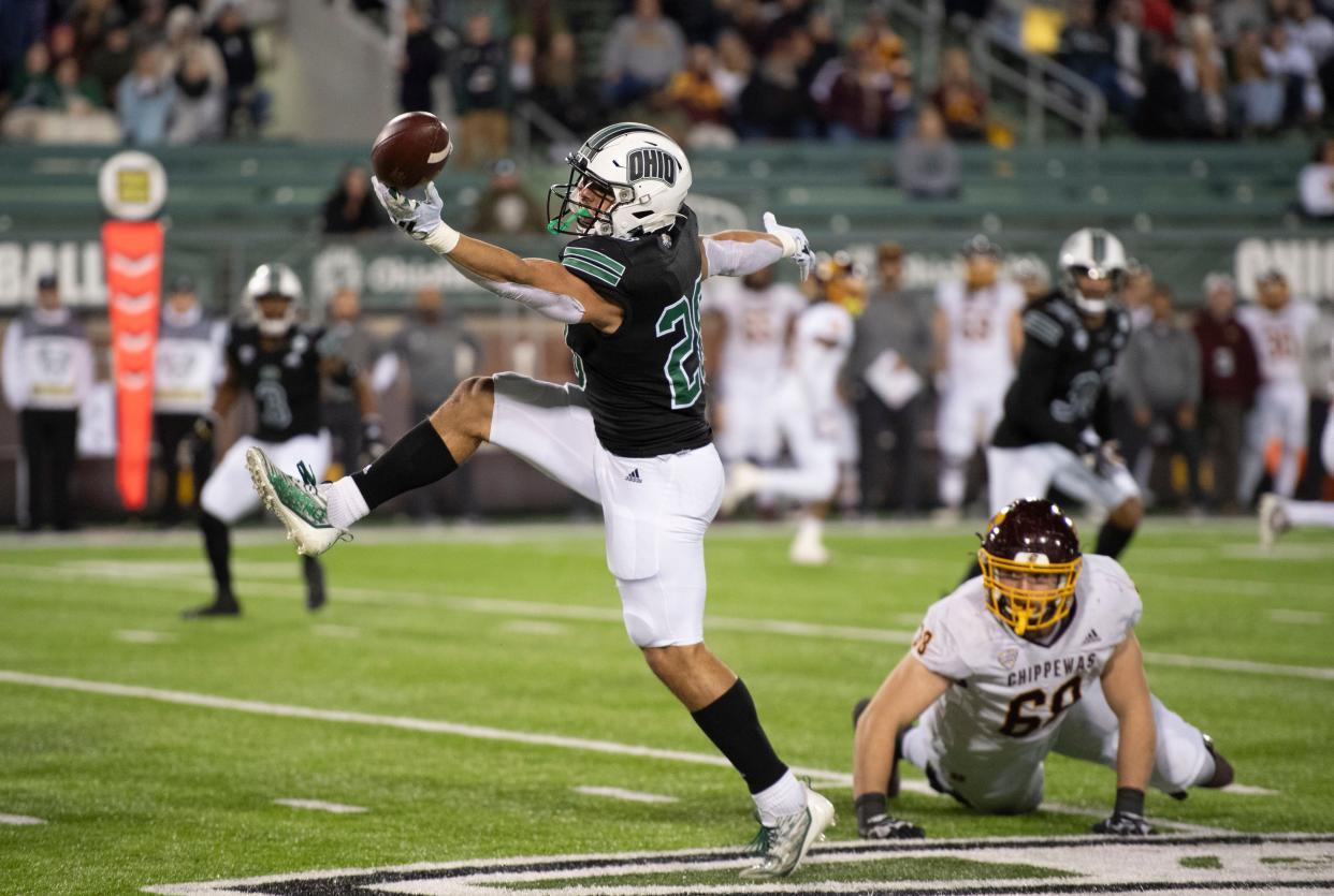Shane Bonner, left, intercepts a pass during Ohio's 34-20 win against visiting Central Michigan on Nov. 15, 2023, at Peden Stadium in Athens. Bonner, a 2018 John Glenn graduate, returned it for his only collegiate touchdown. A sixth-year graduate student, Bonner just wrapped up his final season and is awaiting his upcoming pro day on March 21.