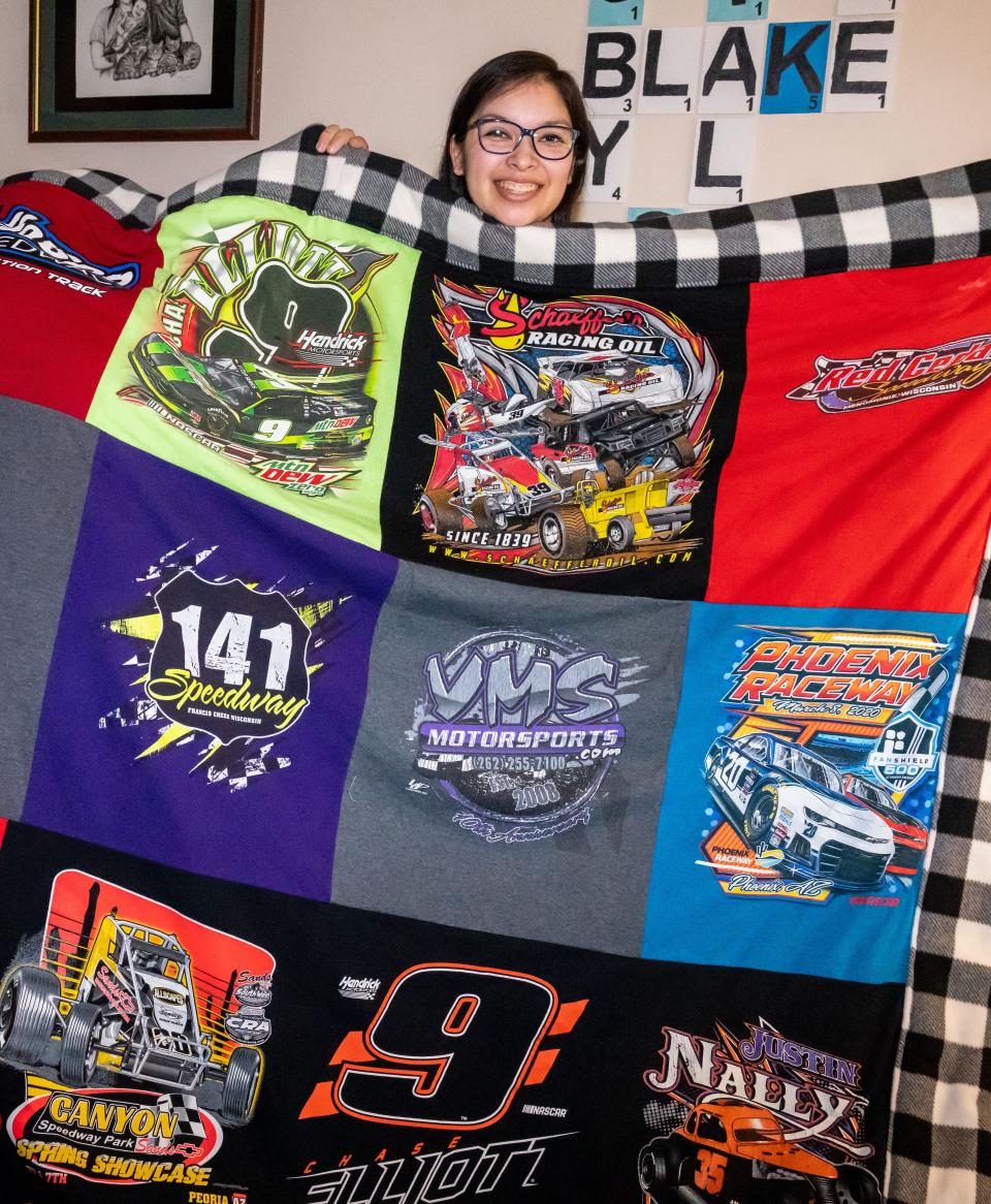Natalie Stremlau of Oak Creek displays one of her motorsports themed quilts in her home, Sunday, May 21, 2023.