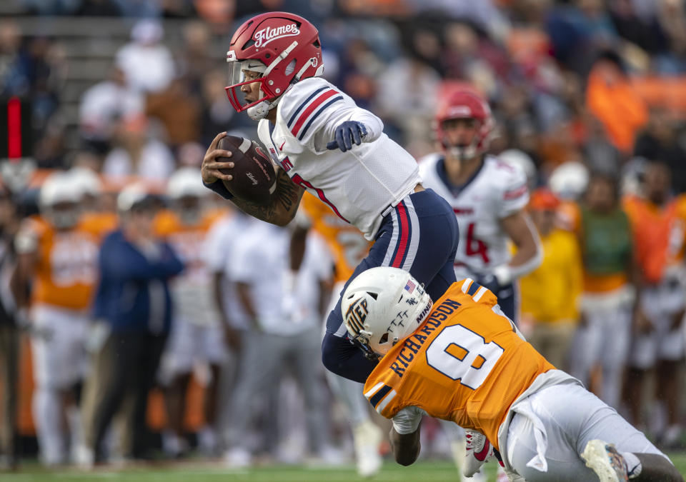 Liberty quarterback Kaidon Salter (7) is tackled by UTEP cornerback Torey Richardson (8) during the first half of an NCAA college football game on Saturday, Nov. 25, 2023, in El Paso, Texas. (AP Photo/Andres Leighton)