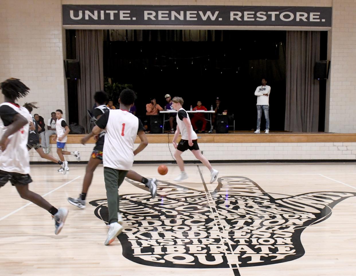 Young men play Monday, April 15, 2024, in a weekly basketball league at The Martin Center, a faith-based nonprofit facility organized in a bid to mentor young men.