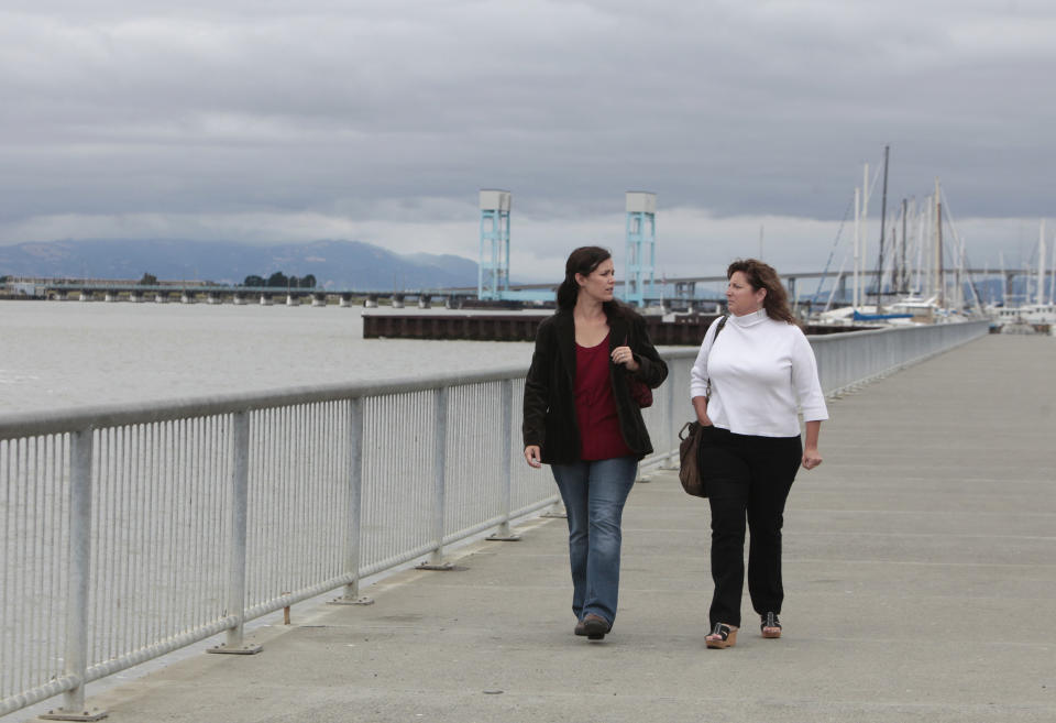 In this photo taken Tuesday, July 17, 2012, Vallejo city council members Stephanie Gomez, left, and Marti Brown, walk the water front in Vallejo, Calif. Both council members support the city's 2008 decision to file for bankruptcy. The city emerged from bankruptcy last year and offers an example for what can come, both good and bad, from the experience. Some in the community say bankruptcy was the city's only option to climb out of a financial hole while others say more could have been done to avoid it.(AP Photo/Rich Pedroncelli)