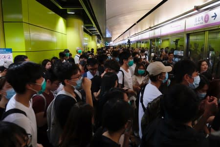 Anti-extradition bill demonstrators block a Mass Transit Railway (MTR) train in Hong Kong