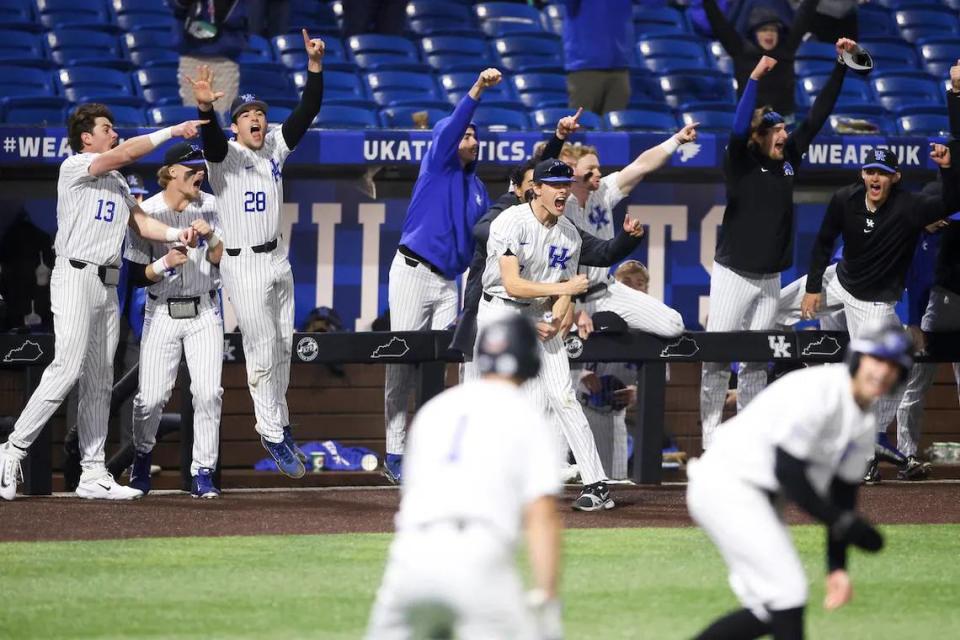 Kentucky’s dugout erupts in celebration during the Wildcats’ eighth-inning rally from a 5-2 deficit to a 9-5 lead as UK won its home opener at Kentucky Proud Park on Tuesday night.