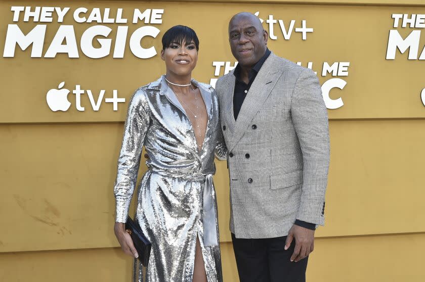 EJ Johnson,left, and Magic Johnson arrive at a premiere