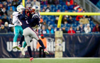 <p>Stephon Gilmore #24 and Duron Harmon #30 of the New England Patriots intercept a pass intended for DeVante Parker #11 of the Miami Dolphins during the fourth quarter of a game at Gillette Stadium on November 26, 2017 in Foxboro, Massachusetts. (Photo by Adam Glanzman/Getty Images) </p>