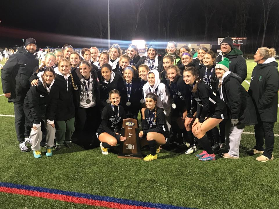 The Pennridge High School girls' soccer team poses with the runner-up trophy following a 2-1 loss to Central Dauphin in the PIAA Class 4A girls soccer championship.