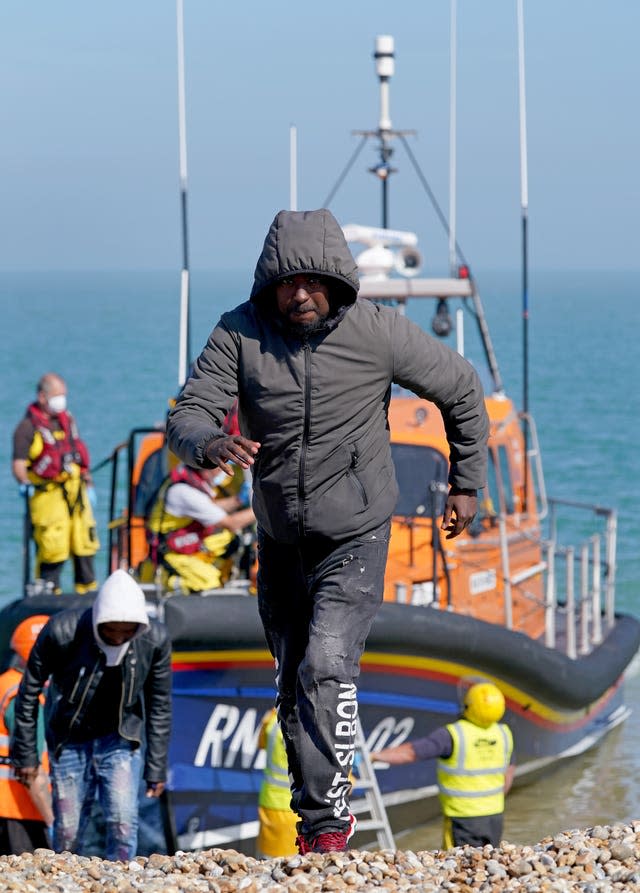A group of people thought to be migrants are brought ashore from the Dungeness lifeboat in Kent