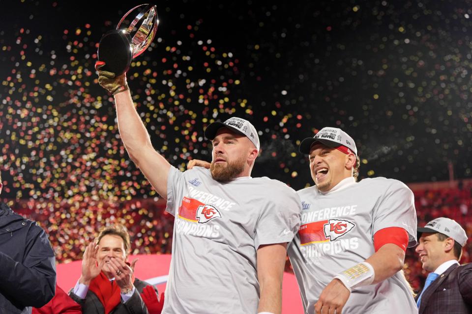 Kansas City Chiefs tight end Travis Kelce (left) and quarterback Patrick Mahomes (15) celebrate after winning the AFC Championship Game against the Cincinnati Bengals.