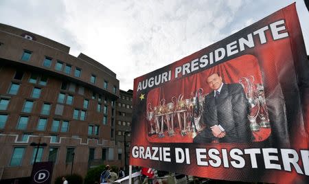 A banner reading "All the best president, thanks for existing" is seen in front of San Raffaele hospital, as Italian surgeons began a four-hour heart operation on former prime minister Silvio Berlusconi on Tuesday to replace a defective aortic valve, a hospital statement said, in Milan, Italy June 14, 2016. REUTERS/Flavio Lo Scalzo