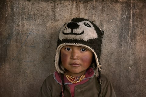 A young child at a market near Quito - Credit: STEVE MCCURRY/SILVERSEA