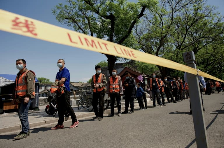 People queue for a swab test for the Covid-19 coronavirus near the entrance of the Forbidden City in Beijing (AFP/Noel Celis)