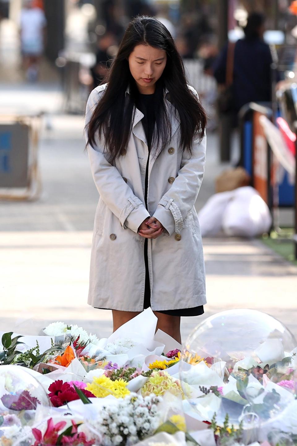 A woman takes a moment to remember those who died in the shopping centre attack (Getty Images)