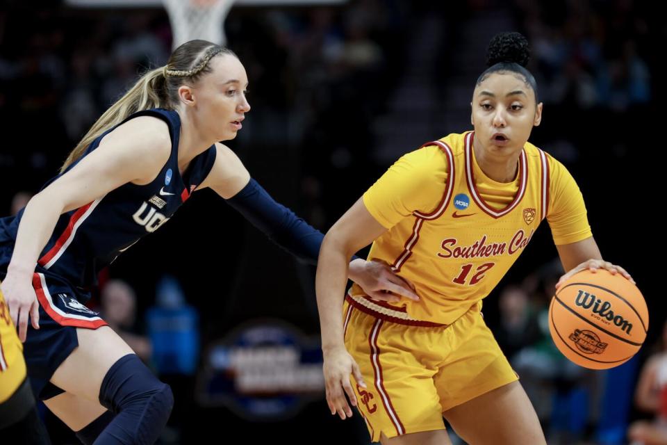 JuJu Watkins of the USC Trojans drives past Paige Bueckers.