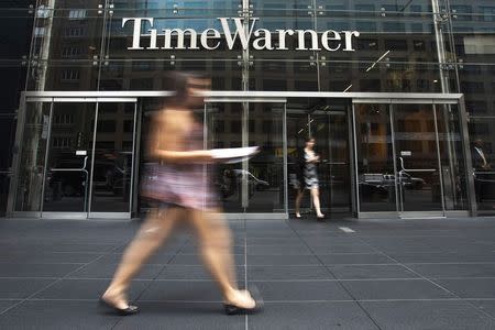 A woman walks past the Time Warner Center near Columbus Circle in Manhattan, New York in this file photo from July 16, 2014. REUTERS/Adrees Latif