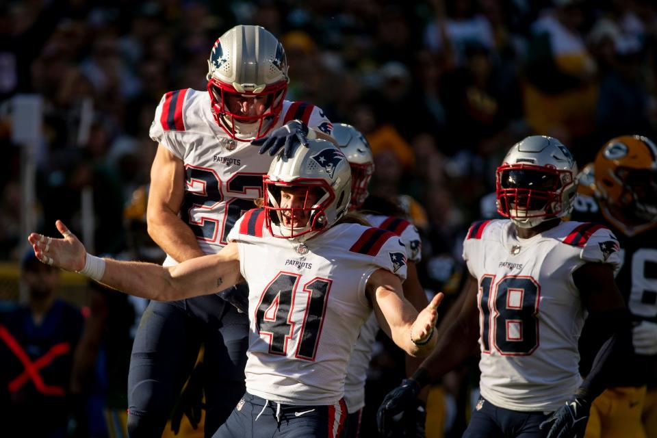 New England Patriots safety Cody Davis (22) and safety Brenden Schooler (41) celebrate in the first half of the game against the Green Bay Packers on Sunday, Oct. 2, 2022, at Lambeau Field in Green Bay, Wis. Samantha Madar/USA TODAY NETWORK-Wis. 