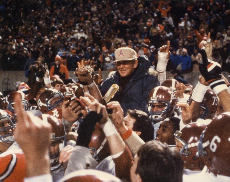 Players carry coach Paul W. "Bear" Bryant off the field after his last game against Illinois in the Liberty Bowl in Memphis, Tennessee, on Dec. 29, 1982.