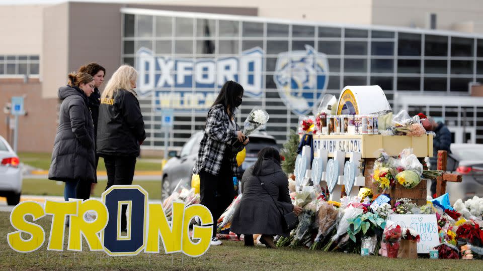 People gather at the memorial for the dead and wounded outside of Oxford High School in Oxford, Michigan. on December 3, 2021. - Jeff Kowalsky/AFP/Getty Images