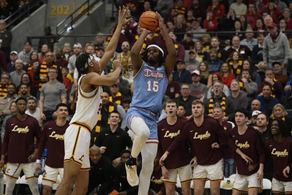 Dayton's DaRon Holmes (15) goes up to shoot against Loyola of Chicago's Miles Rubin, front left, during the first half of an NCAA college basketball game Friday, March 1, 2024, in Chicago. (AP Photo/Paul Beaty)
