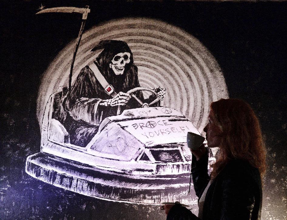 A restored wall graffiti artwork by famed street artist Banksy, is put on display to the public, Thursday April 24, 2014, in London. The artworks are taken from street walls, restored and presented for sale, valued at up to 1 million pounds (US $1.68 million). Seven pieces of Banksy graffiti art are being sold at auction on Sunday April 27, although the elusive artist released a statement on Banksy’s website Thursday saying the "Stealing Banksy?" sale "has been organized without the involvement or consent of the artist." (AP Photo / John Stillwell, PA) UNITED KINGDOM OUT - NO SALES - NO ARCHIVES