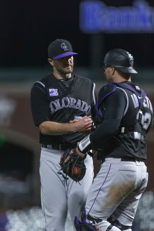 May 17, 2018; San Francisco, CA, USA; Colorado Rockies catcher Chris Iannetta (22) congratulates relief pitcher Wade Davis (71) at end of game against the San Francisco Giants at AT&T Park. Mandatory Credit: Neville E. Guard-USA TODAY Sports