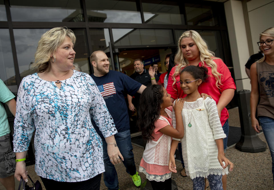 FILE - In this May 28, 2018, file photo, Laurie Holt, left, walks out of the airport with her son, Josh Holt, walking behind her, after returning to Salt Lake City after Josh and his family received medical care and visited President Donald Trump in Washington. Laurie Holt, a Utah woman who spent nearly two years pushing to get her son freed from a Venezuelan jail, has died at age 50. (AP Photo/Kim Raff, File)