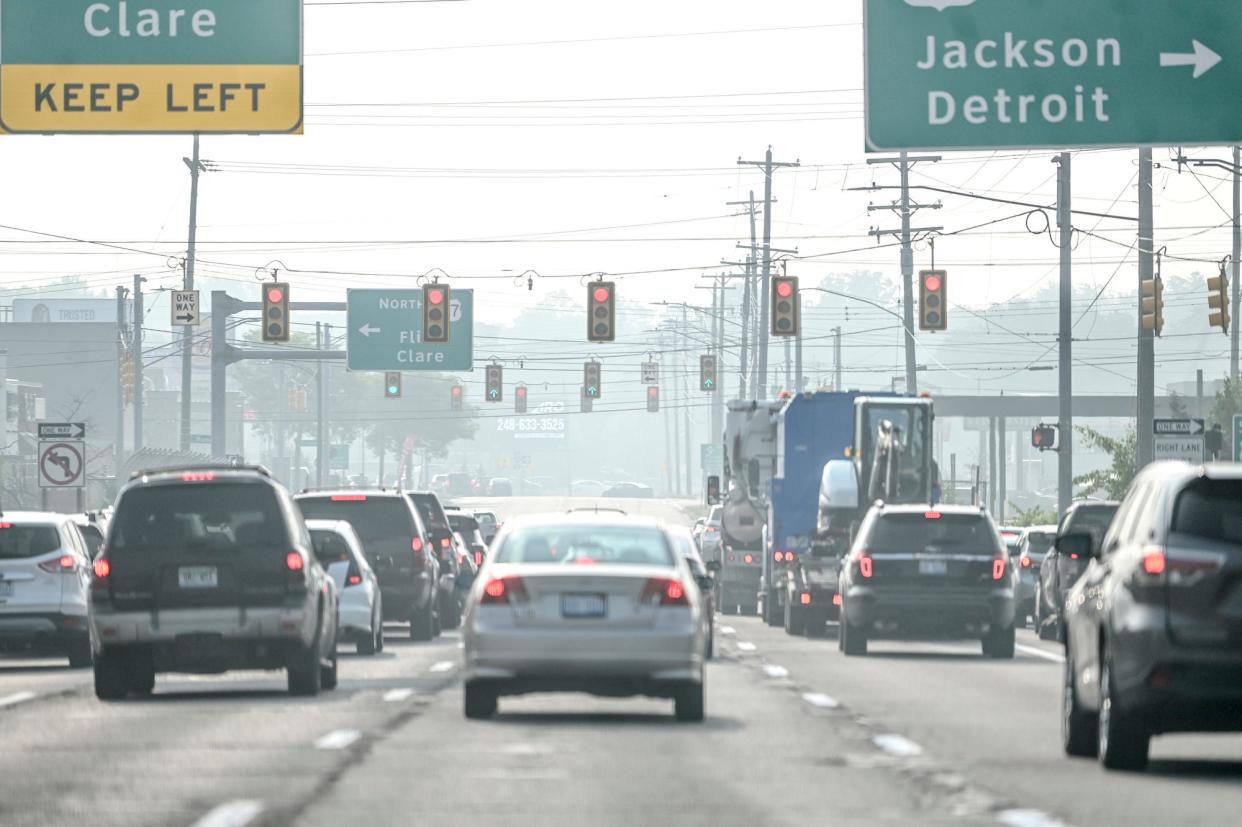 Traffic moves along through the haze on Saginaw Street near the Frandor Shopping Center on Wednesday, June 28, 2023, in Lansing.