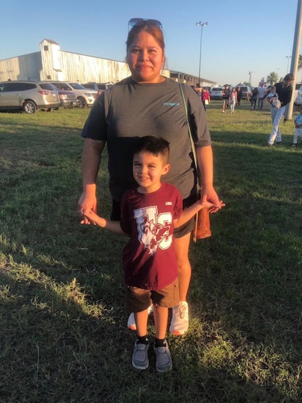 Brianna Gonzales picked her fourth-grader up early from Robb Elementary on Tuesday, not long before the shooting started; she stands outside the Uvalde County Fairplex with her younger son, Emilio (Sheila Flynn)