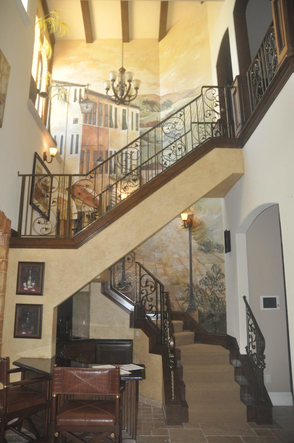 The two story wall beside the staircase was hand painted to look like a scene from Venice.