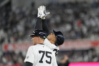 New York Yankees' Juan Soto, right, reacts after hitting an RBI single in the sixth inning of a baseball game against the Miami Marlins, Tuesday, April 9, 2024, in New York. (AP Photo/Mary Altaffer)