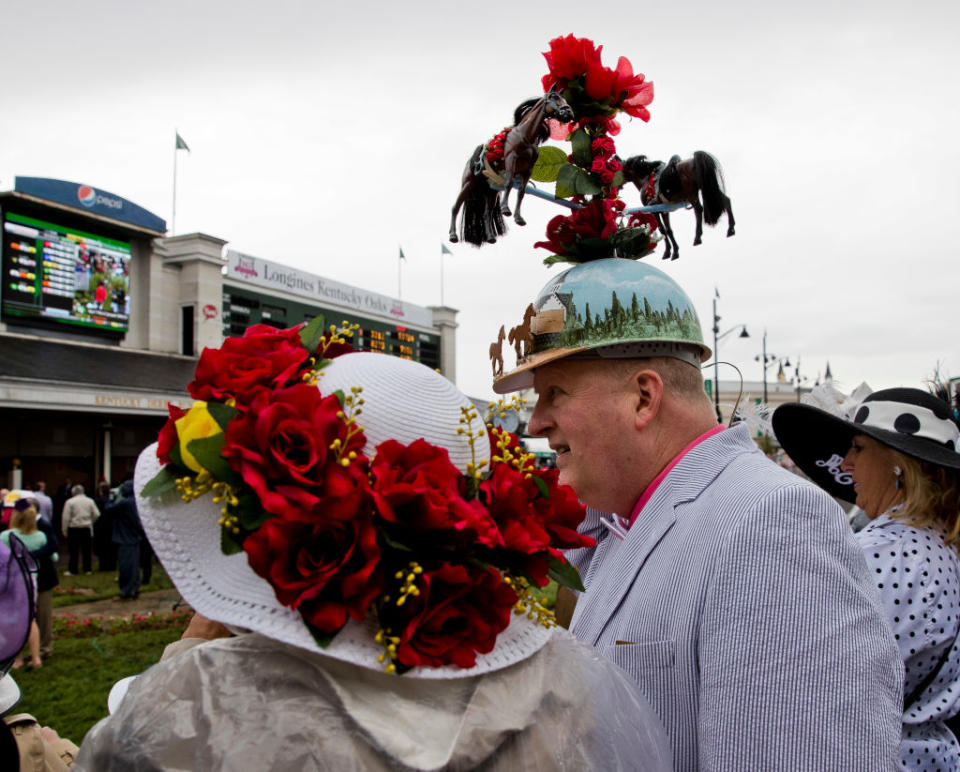 <p>This couple is sporting fancy hats together for the occasion. (Photo: Jesse Caris/Eclipse Sportswire/Getty Images) </p>