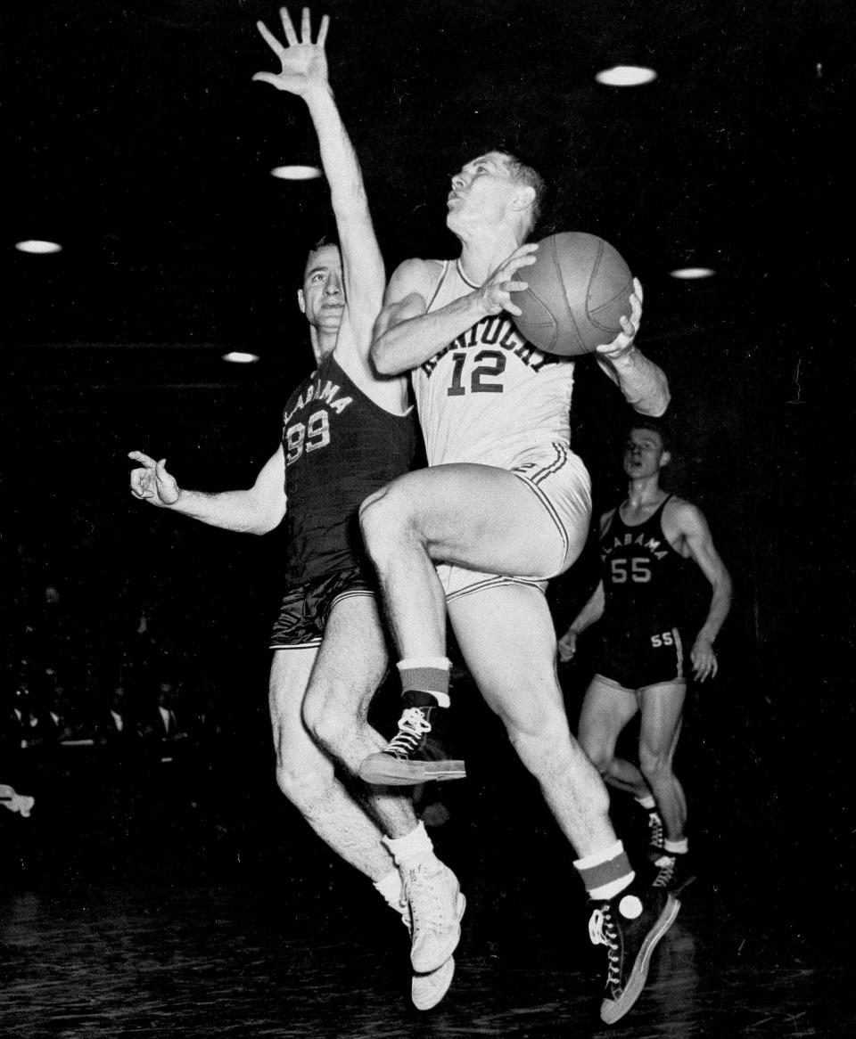 FILE - University of Kentucky's Ralph Beard (12) takes off for a shot at the basket as Hayden Riley (99) of Alabama defends, in Lexington, Kentucky, Feb. 16, 1948. When the first AP Top 25 men's college basketball poll was published in January 1949, Saint Louis was installed at No. 1 ahead of mighty Kentucky, thanks to a head-to-head win in the Sugar Bowl Championship game a few weeks earlier in New Orleans. (AP Photo/File)