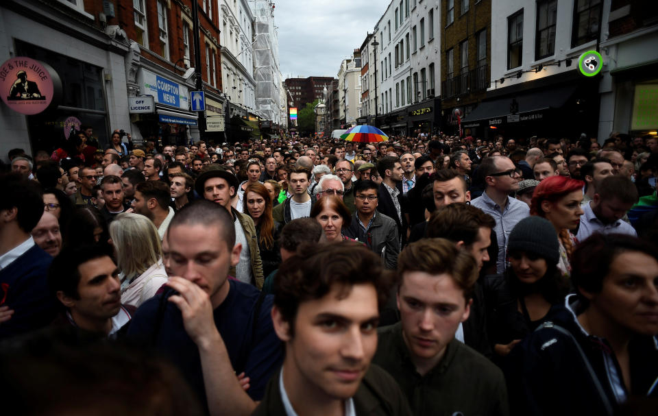 People pause during a minute's silence in memory of the victims of the gay nightclub mass shooting in Orlando, in the Soho district of London, June 13, 2016.&nbsp;