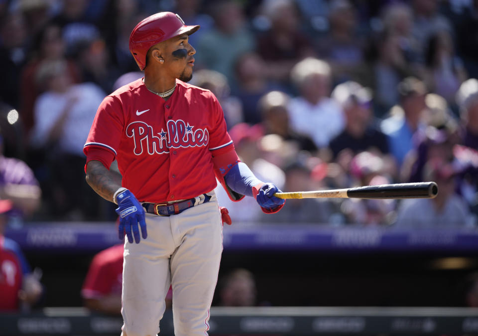 Philadelphia Phillies' Johan Camargo follows the flight of his three-run home run off Colorado Rockies relief pitcher Lucas Gilbreath in the seventh inning of a baseball game Wednesday, April 20, 2022, in Denver. (AP Photo/David Zalubowski)