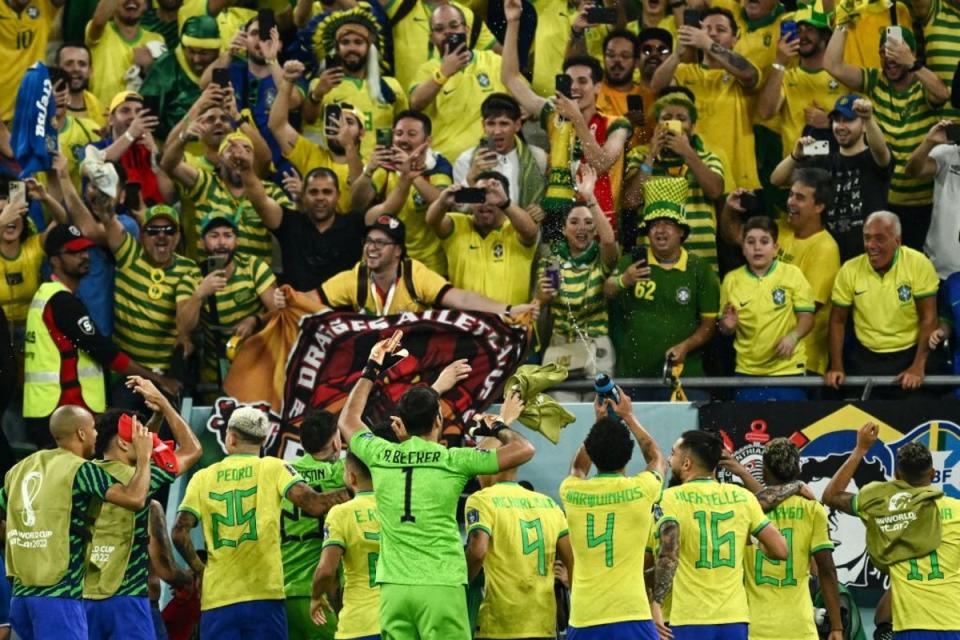 Brazil's players gesture to the fans after their team's win (AFP via Getty Images)