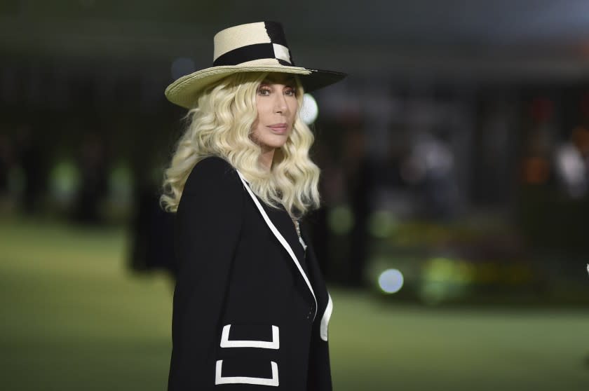 A blond woman in a wide-brimmed hat