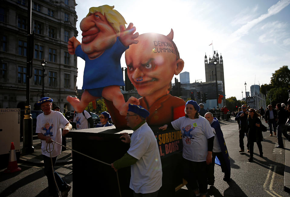 Figures depicting Britain's Prime Minister Boris Johnson and his special advisor Dominic Cummings are displayed during a demonstration as parliament sits on a Saturday for the first time since the 1982 Falklands War, to discuss Brexit in London, Britain, October 19, 2019. REUTERS/Henry Nicholls