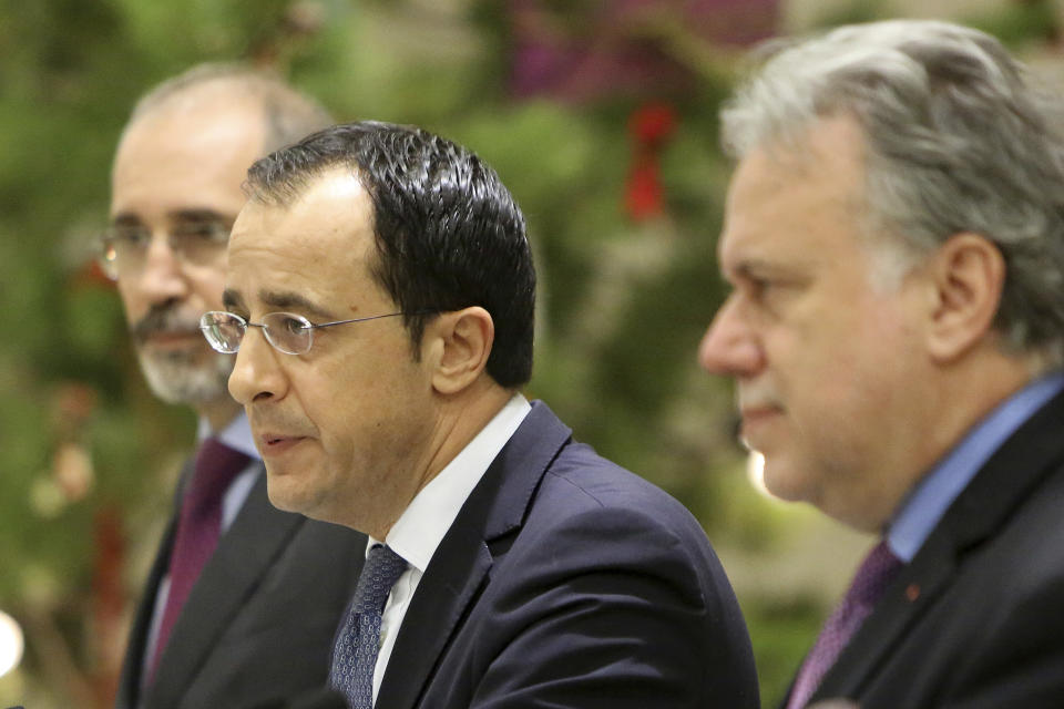 Cypriot foreign minister Nicos Christodoulides, center, Foreign minister of Jordan Ayman Safadi, left, and the Greek Alternate Minister of Foreign Affairs Georgios Katrougalos talk to the media during a press conference after their meeting at the presidential palace in Nicosia, Cyprus, Wednesday, Dec. 19, 2018. The three ministers are meeting in the Cypriot capital to explore ways of strengthening ties on fields as varied as education and entrepreneurship. (AP Photo/Petros Karadjias)