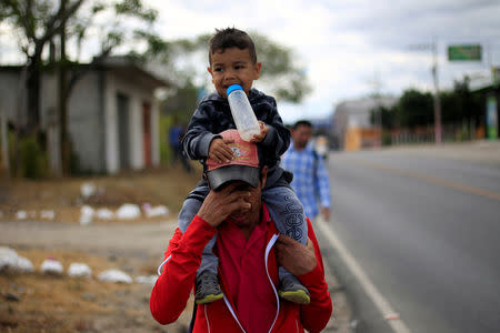 Migrants from Honduras, part of a new caravan from Central America trying to reach the United States, walk along a road in Chiquimula, Guatemala January 16, 2019. REUTERS/Jorge Cabrera