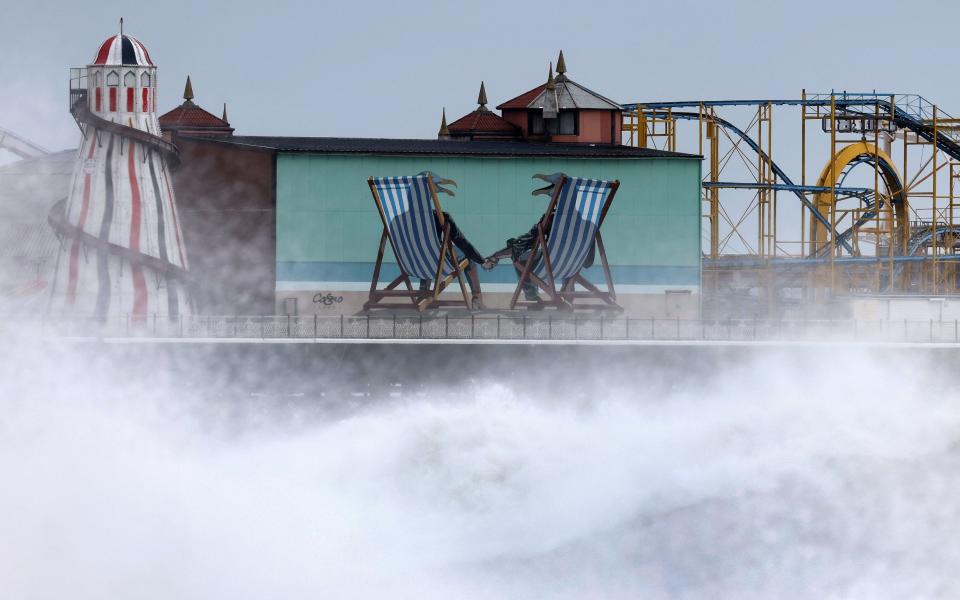A high tidal surge breaks at Brighton Pier in Brighton on Nov 2