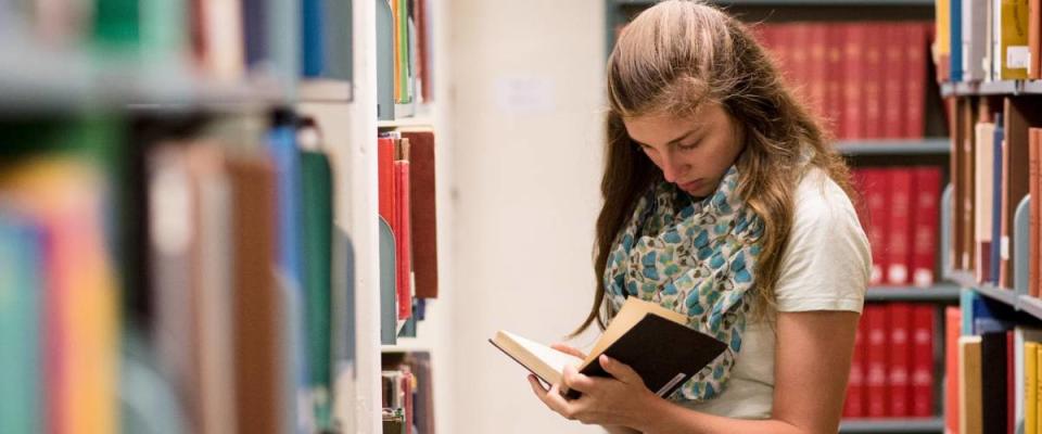 Student reading a book at university of Virginia library