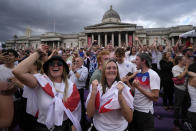 England supporters celebrate after Chloe Kelly scored their second goal as they gather in the fan zone in Trafalgar Square to watch on a big screen the final of the Women's Euro 2022 soccer match between England and Germany being played at Wembley stadium in London, Sunday, July 31, 2022. (AP Photo/Frank Augstein)