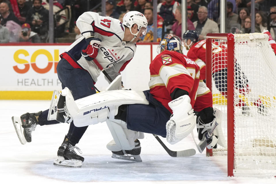 Washington Capitals left wing Beck Malenstyn (47) is called for interference against Florida Panthers goaltender Sergei Bobrovsky (72) during the first period of an NHL hockey game Thursday, Feb. 8, 2024, in Sunrise, Fla. (AP Photo/Jim Rassol)