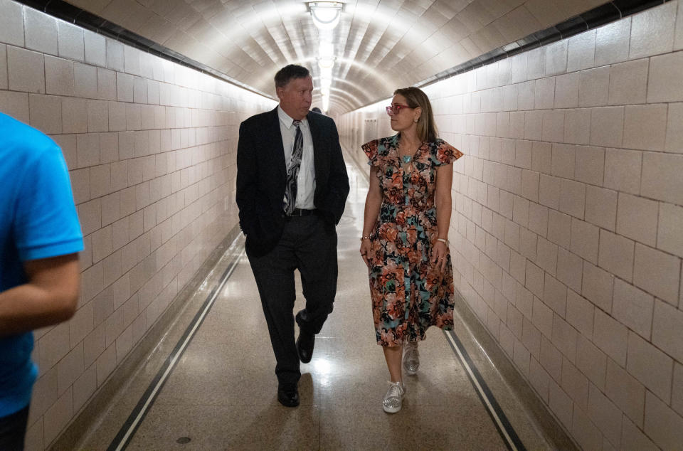 Sen. Kyrsten Sinema and Tom Buschatzke, director of the Arizona Department of Water Resources, talk during a tour of Hoover Dam on the Arizona/Nevada border, Aug. 8, 2022.